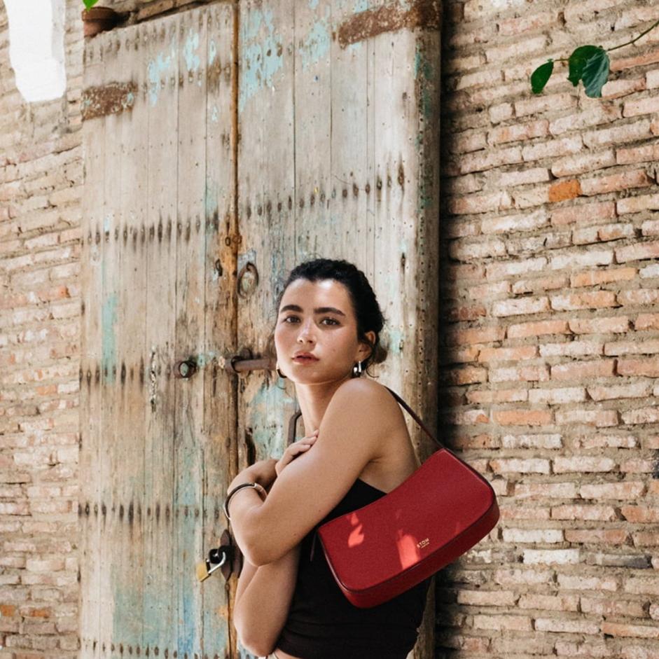 STOW London Post Shoulder Bag in Red leather being worn by model in Tangiers