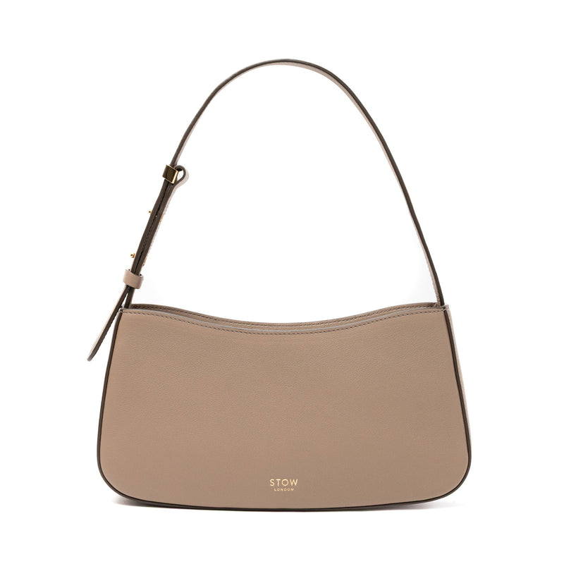STOW London's Post Shoulder bag in Warm Taupe smooth leather featuring gold-coated stainless steel hardware on a white background