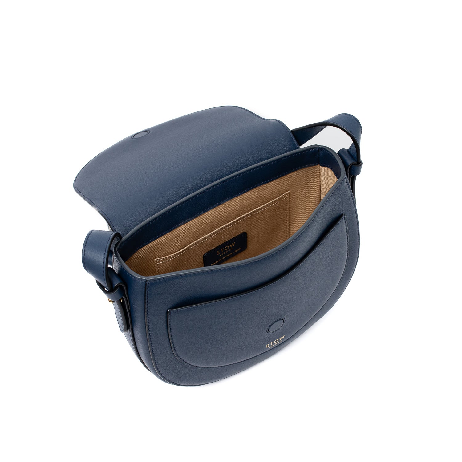 Top angled view of STOW London's Saddle bag in Navy smooth leather with flap open showing interior cotton lining and card holder pocket featuring gold-coated stainless steel hardware and clean magnetic closures on a white background