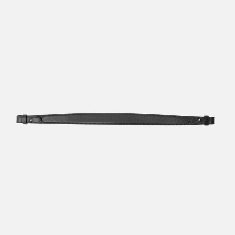 Detachable shoulder strap for STOW London's Curve, Midi Curve and East West in Black smooth leather on a light grey background featuring silver hardware 