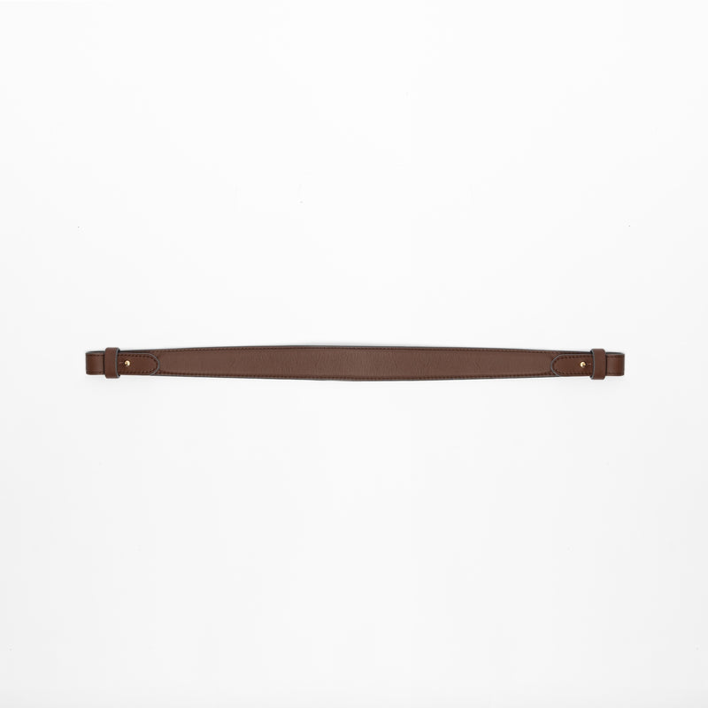 Detachable shoulder strap for STOW London's Curve, Midi Curve and East West in Chocolate smooth leather on a light grey background featuring gold hardware 