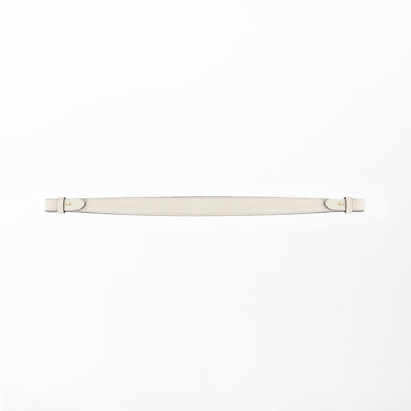 Detachable shoulder strap for STOW London's Curve, Midi Curve and East West in Cloud Grey smooth leather on a light grey background featuring gold hardware 