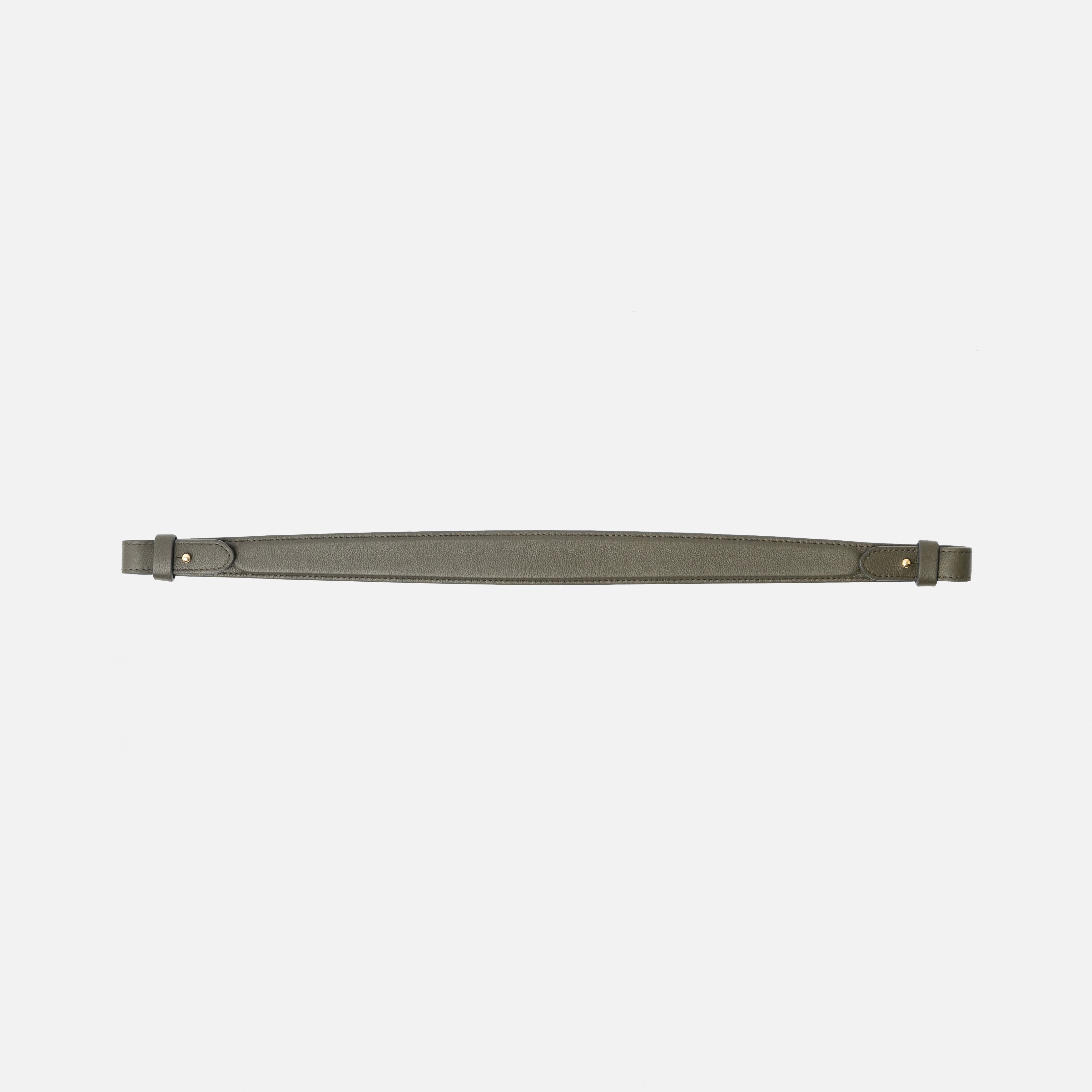 Detachable shoulder strap for STOW London's Curve, Midi Curve and East West in Dark Green smooth leather on a light grey background featuring gold hardware 