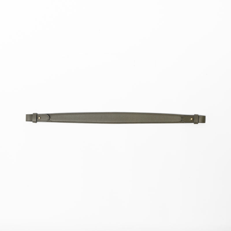 Detachable shoulder strap for STOW London's Curve, Midi Curve and East West in Dark Green smooth leather on a light grey background featuring gold hardware 
