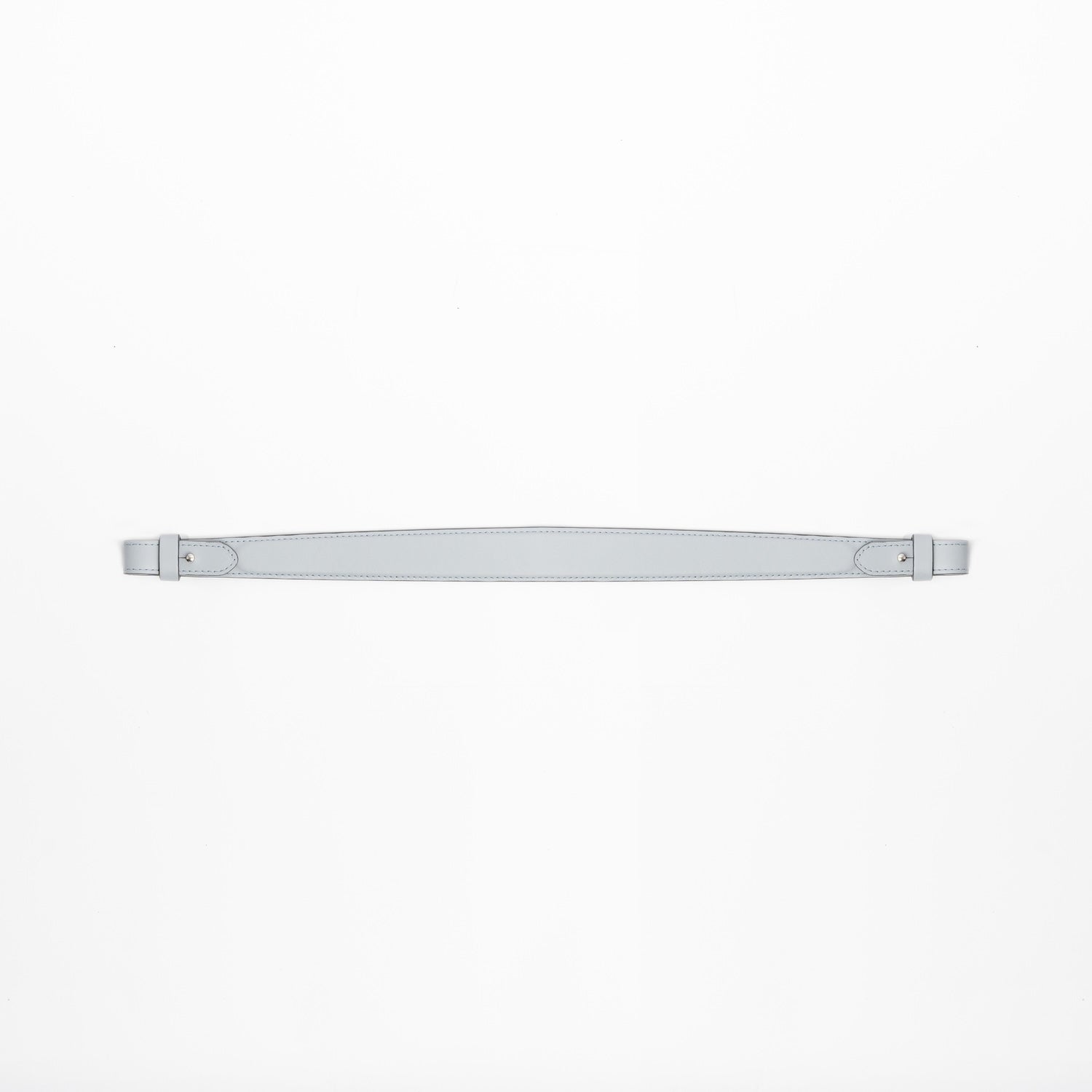Detachable shoulder strap for STOW London's Curve, Midi Curve and East West in Misty Blue smooth leather on a light grey background featuring silver hardware 