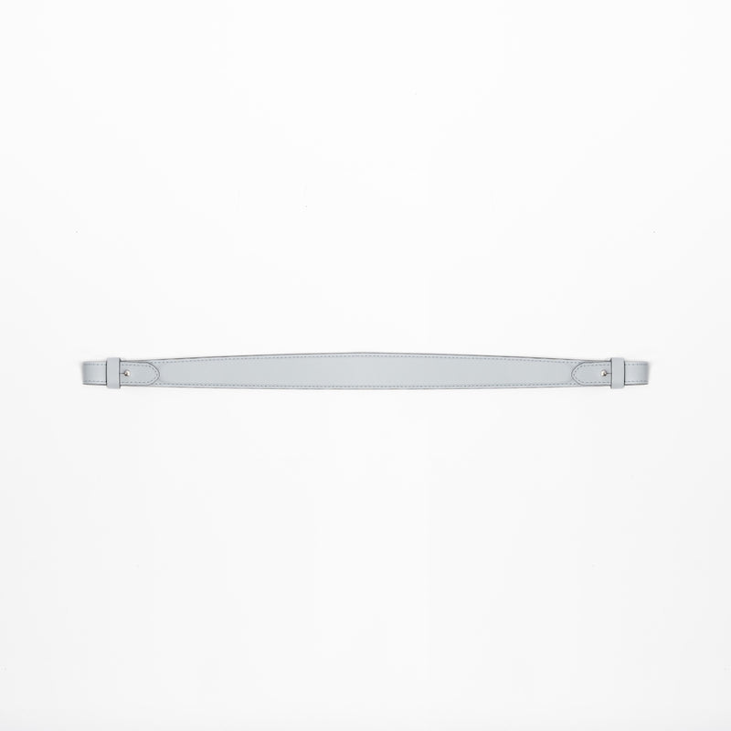 Detachable shoulder strap for STOW London's Curve, Midi Curve and East West in Misty Blue smooth leather on a light grey background featuring silver hardware 