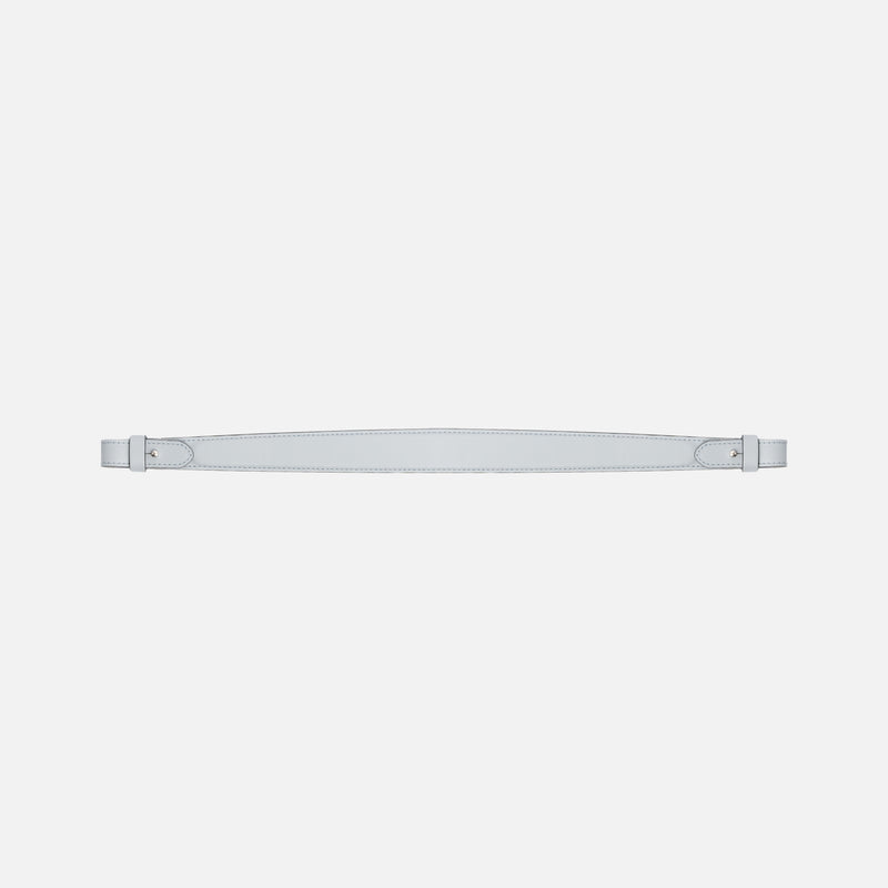 Detachable shoulder strap for STOW London's Curve, Midi Curve and East West in Misty Blue smooth leather on a light grey background featuring gold hardware 