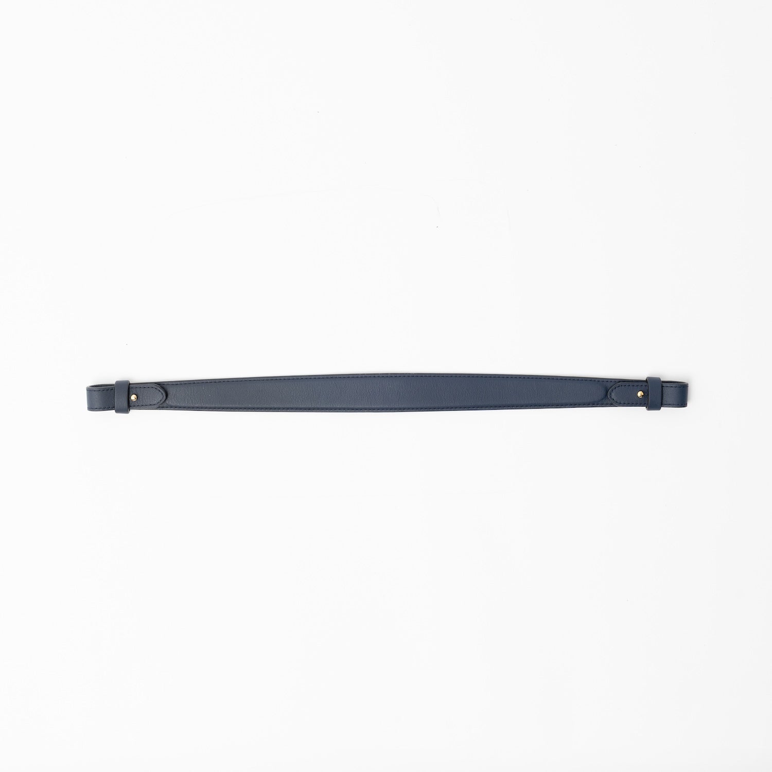 Detachable shoulder strap for STOW London's Curve, Midi Curve and East West in Navy smooth leather on a light grey background featuring gold hardware 