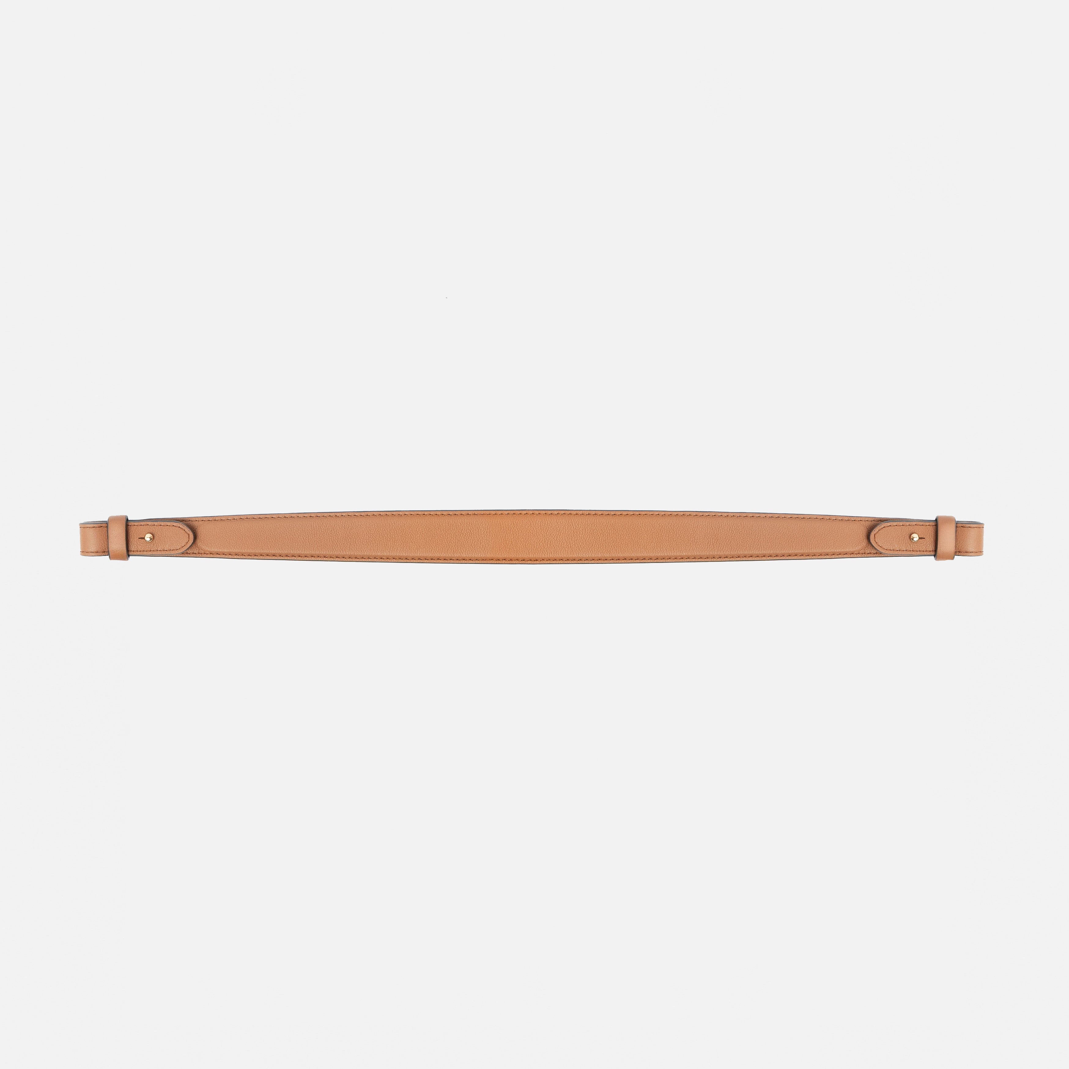 Detachable shoulder strap for STOW London's Curve, Midi Curve and East West in Earth Tan smooth leather on a light grey background featuring gold hardware 