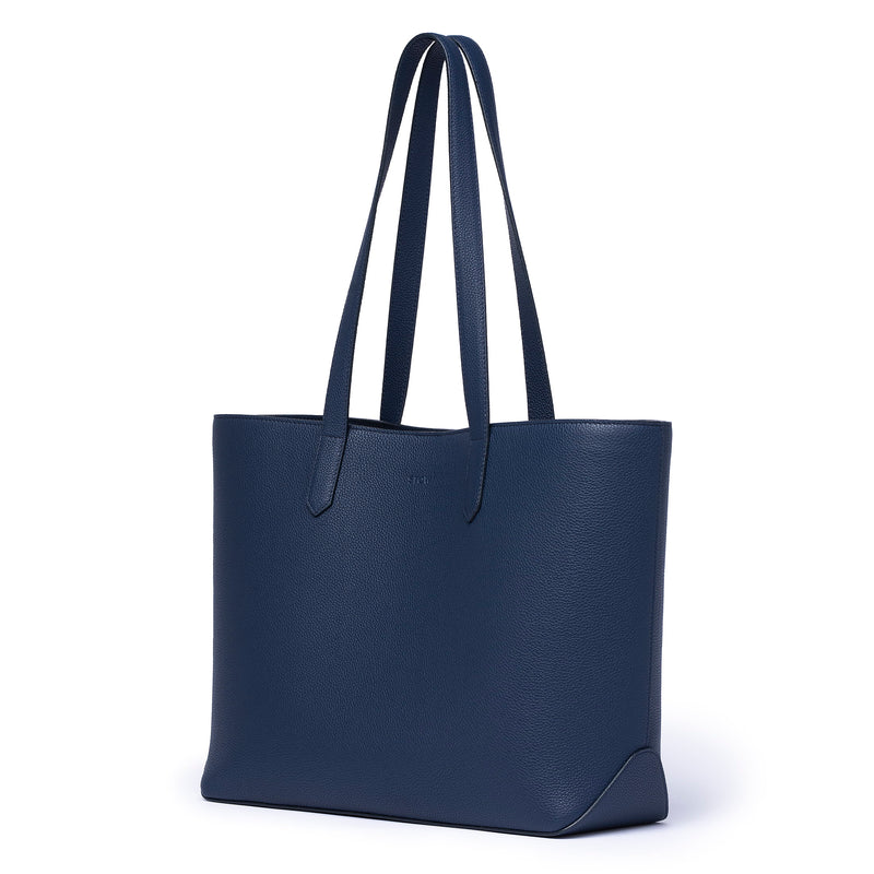STOW Navy Leather Everyday Tote Bag. Bag being shown diagonally facing..