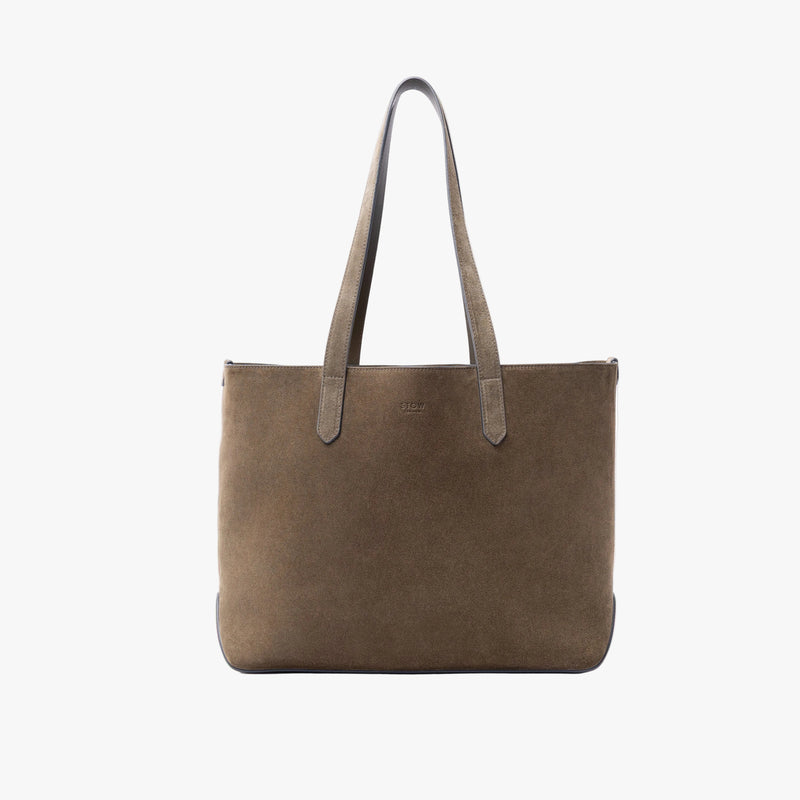 STOW London's Everyday Tote bag in Dark Green suede on a light grey background featuring a small STOW London logo embossed on the front panel