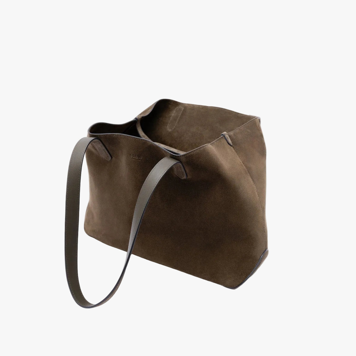 STOW London's Everyday Tote bag in Dark Green suede on a light grey background featuring a small STOW London logo embossed on the front 