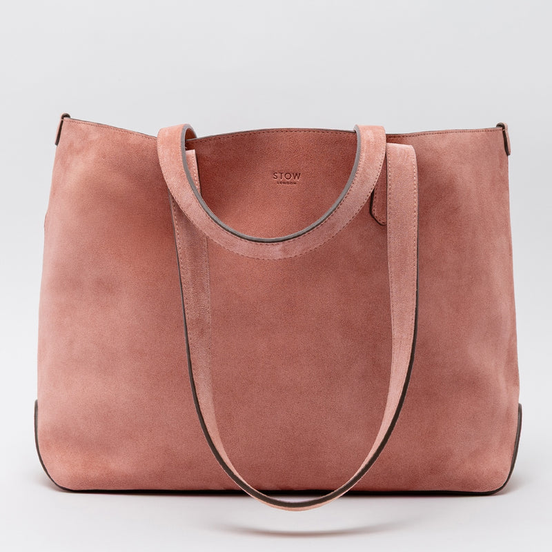 STOW London's Everyday Tote bag in Hazy Blush suede on a light grey background featuring a small STOW London logo embossed on the front panel 