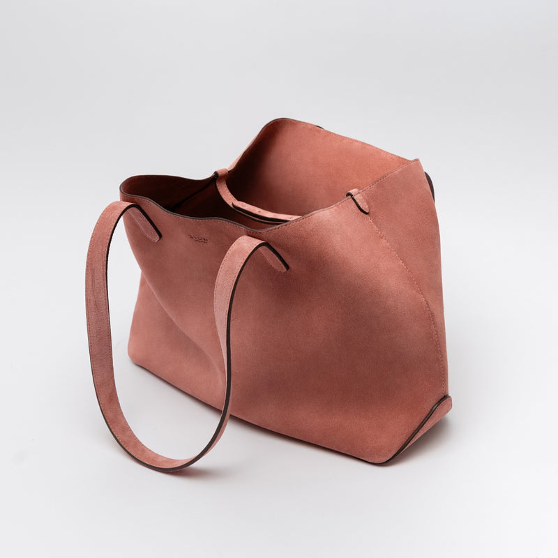 STOW London's Everyday Tote bag in Hazy Blush suede on a light grey background featuring the interior strap and a small STOW London logo embossed on the front panel 