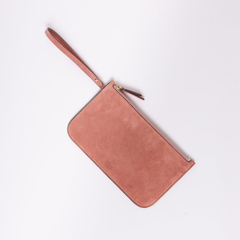 The detachable, internal zip pouch from STOW London's Everyday Tote bag in Hazy Blush suede featuring gold hardware
