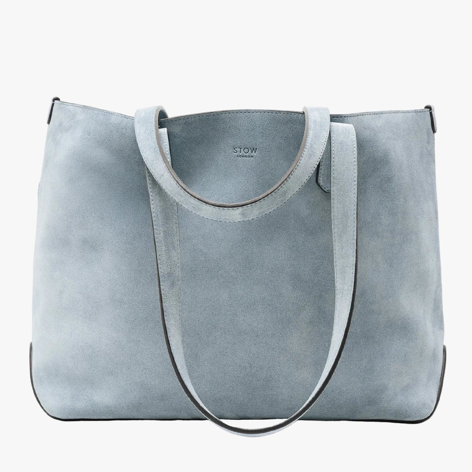 STOW London's Everyday Tote bag in Misty Blue suede on a light grey background featuring a small STOW London logo embossed on the front panel 