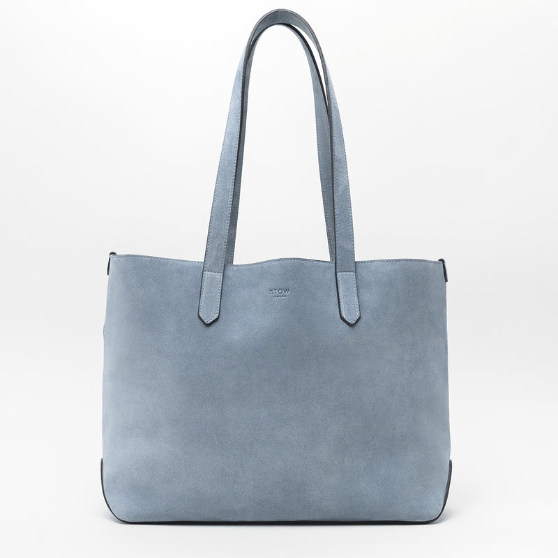 STOW London's Everyday Tote bag in Misty Blue suede on a light grey background featuring a small STOW London logo embossed on the front panel 