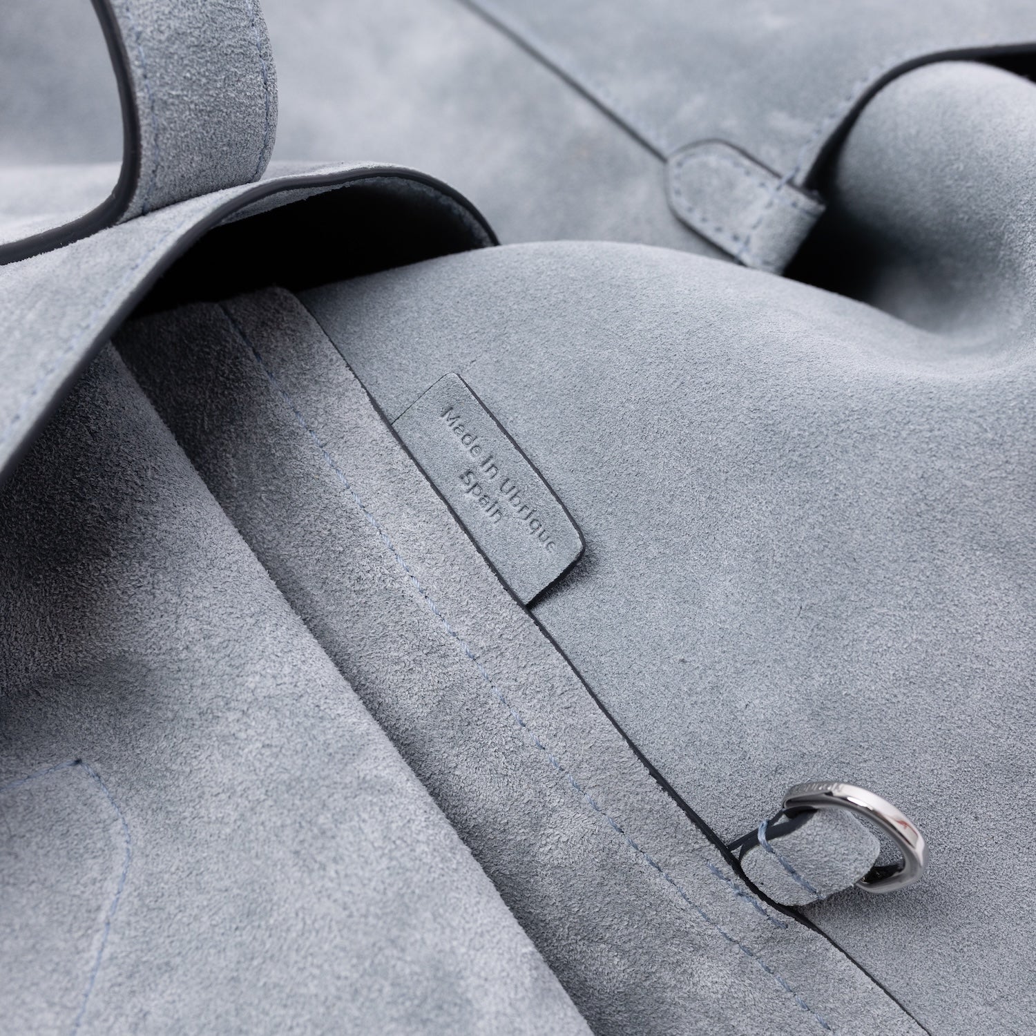 Close up of the interior d-ring and Made In Ubrique tag on STOW London's Everyday Tote bag in Misty Blue suede 