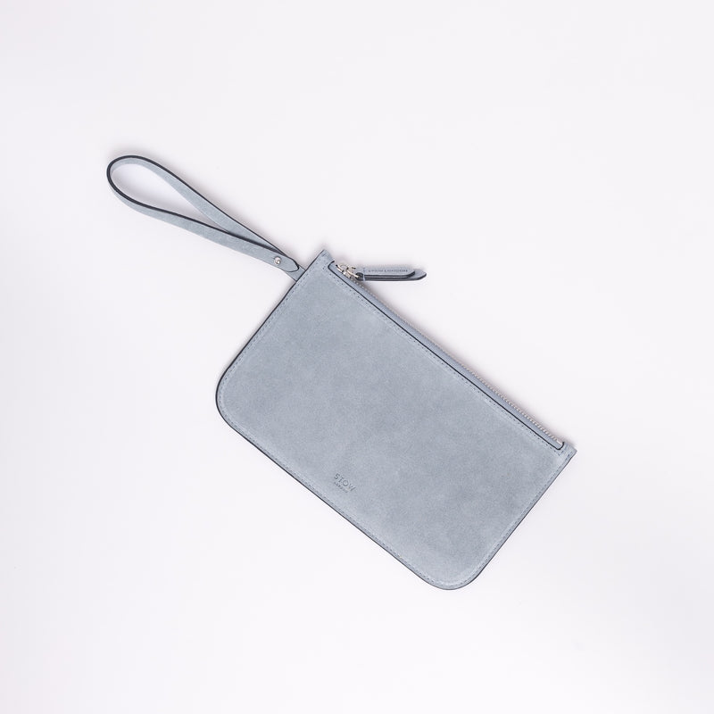The detachable, internal zip pouch from STOW London's Everyday Tote bag in Misty Blue suede featuring silver hardware