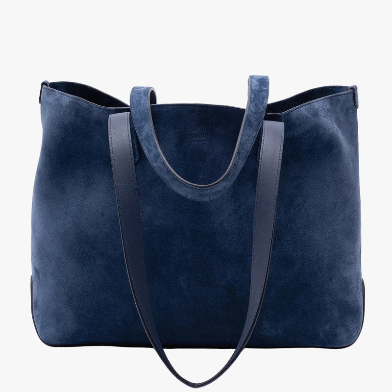 STOW London's Everyday Tote bag in Navy suede on a light grey background featuring a small STOW London logo embossed on the front panel