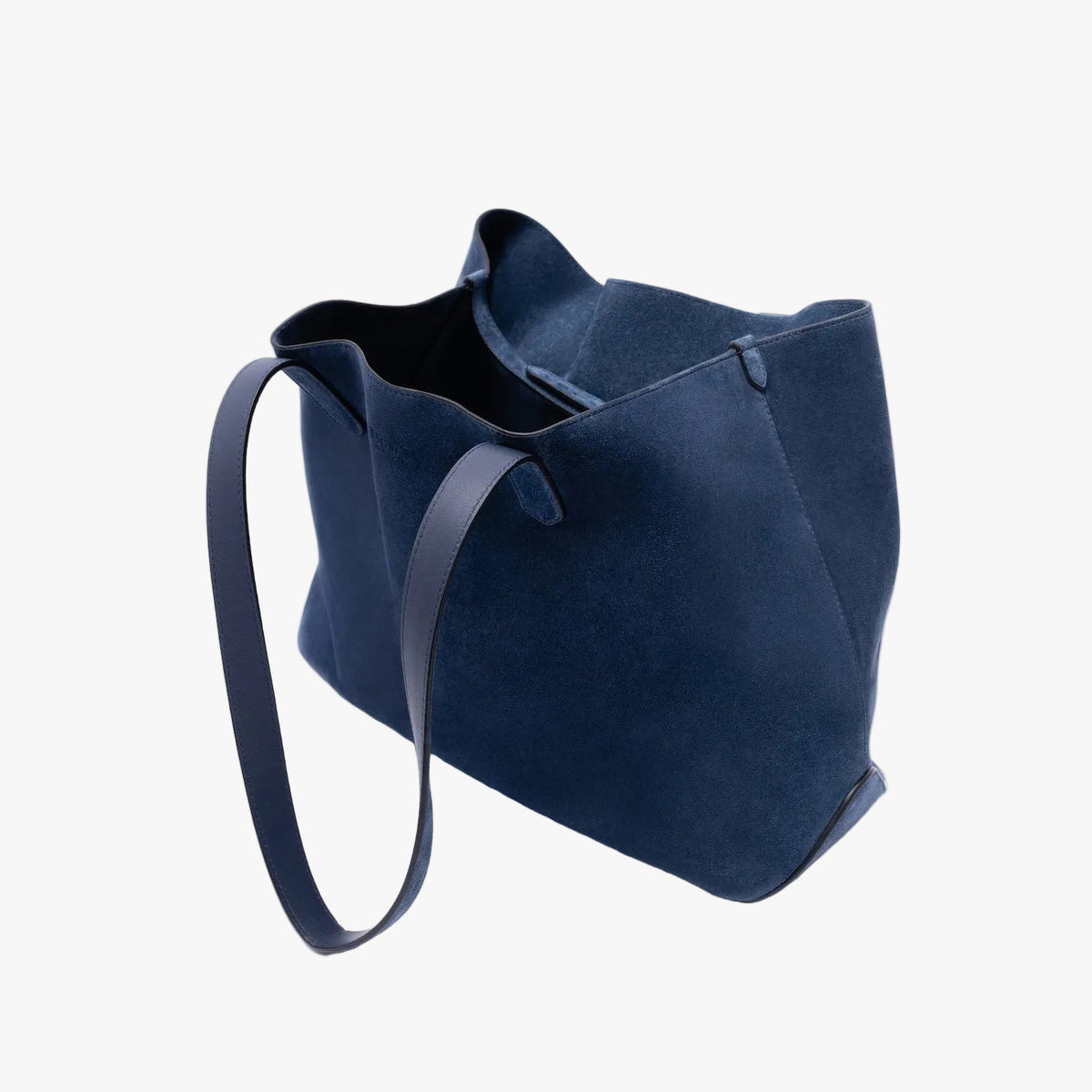 STOW London's Everyday Tote bag in Navy suede on a light grey background featuring a small STOW London logo embossed on the front 