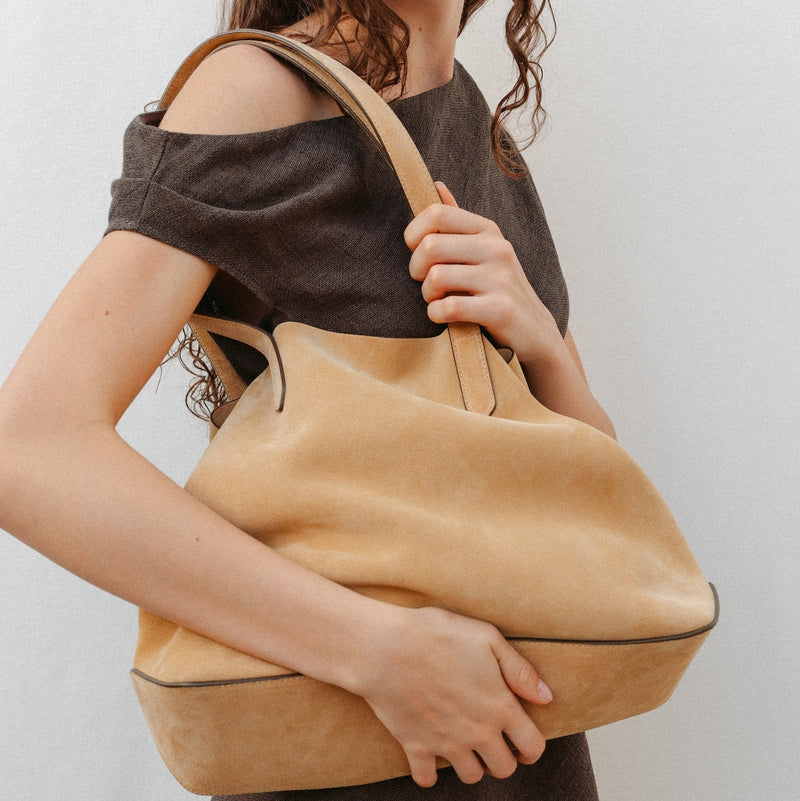 Model wearing STOW London's summer Everyday Tote in Soft Sand Suede on her shoulder