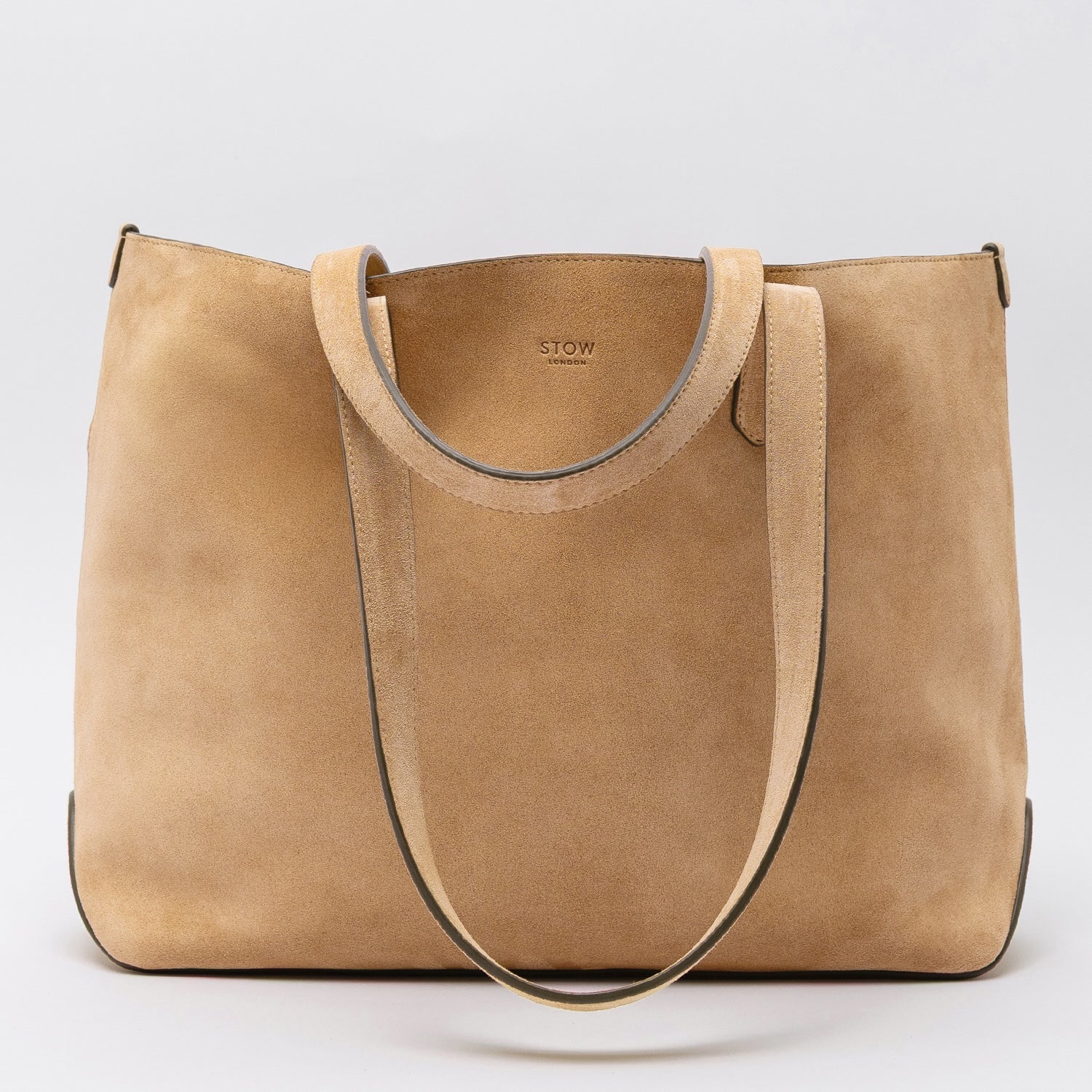 STOW London's Everyday Tote bag in Soft Sand suede on a light grey background featuring a small STOW London logo embossed on the front panel 