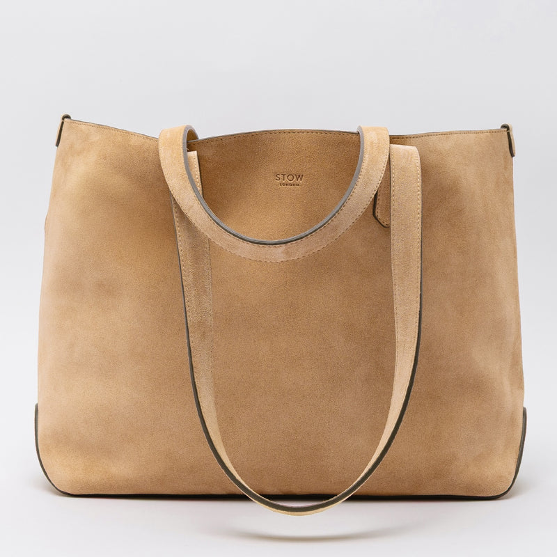 STOW London's Everyday Tote bag in Soft Sand suede on a light grey background featuring a small STOW London logo embossed on the front panel 