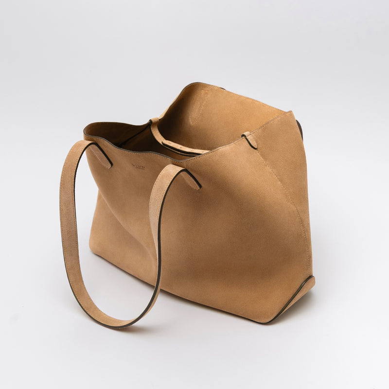 STOW London's Everyday Tote bag in Soft Sand suede on a light grey background featuring the interior strap and a small STOW London logo embossed on the front panel 