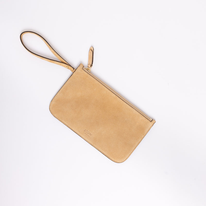 The detachable, internal zip pouch from STOW London's Everyday Tote bag in Soft Sand suede featuring gold hardware
