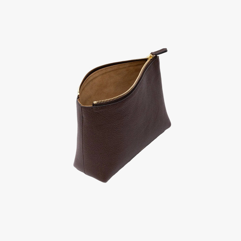 Off-axis view of STOW London's travel pouch in Espresso pebbled leather on a light grey background with the zip open showing the suede interior 