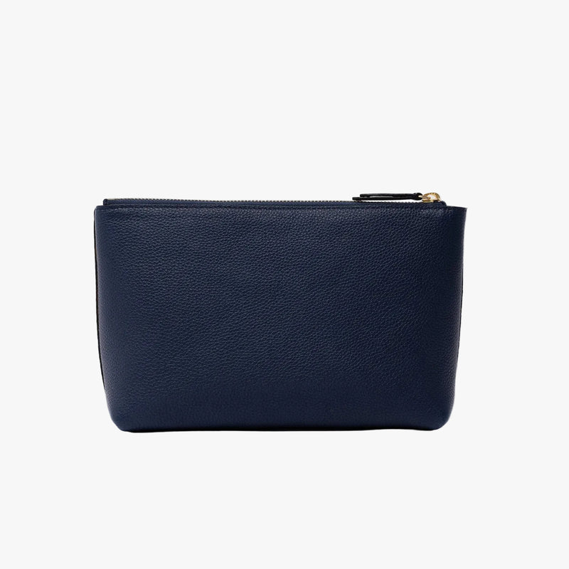 Back panel of STOW London's travel pouch in Navy pebbled leather on a light grey background featuring a YKK zip 