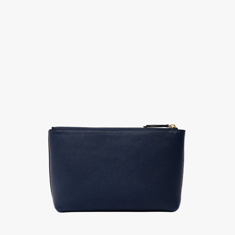Back panel of STOW London's travel pouch in Navy pebbled leather on a light grey background featuring a YKK zip 