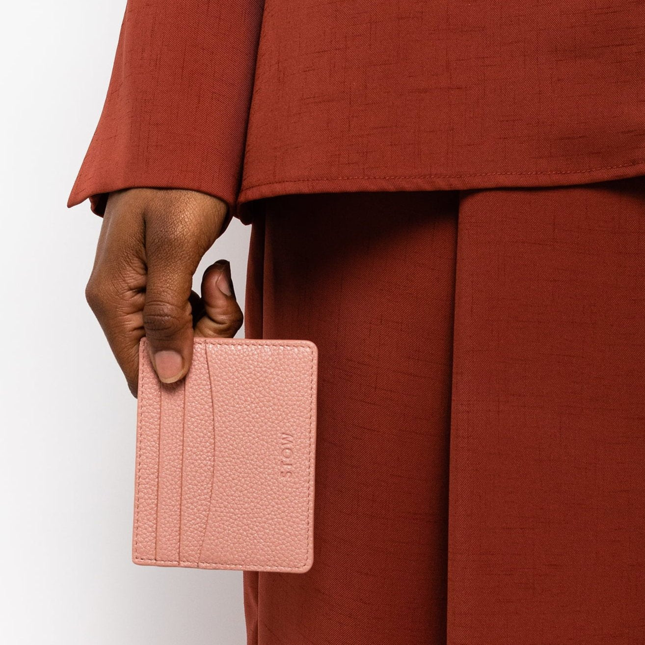 STOW London Leather Cardholder in Hazy Blush held by female model in studio