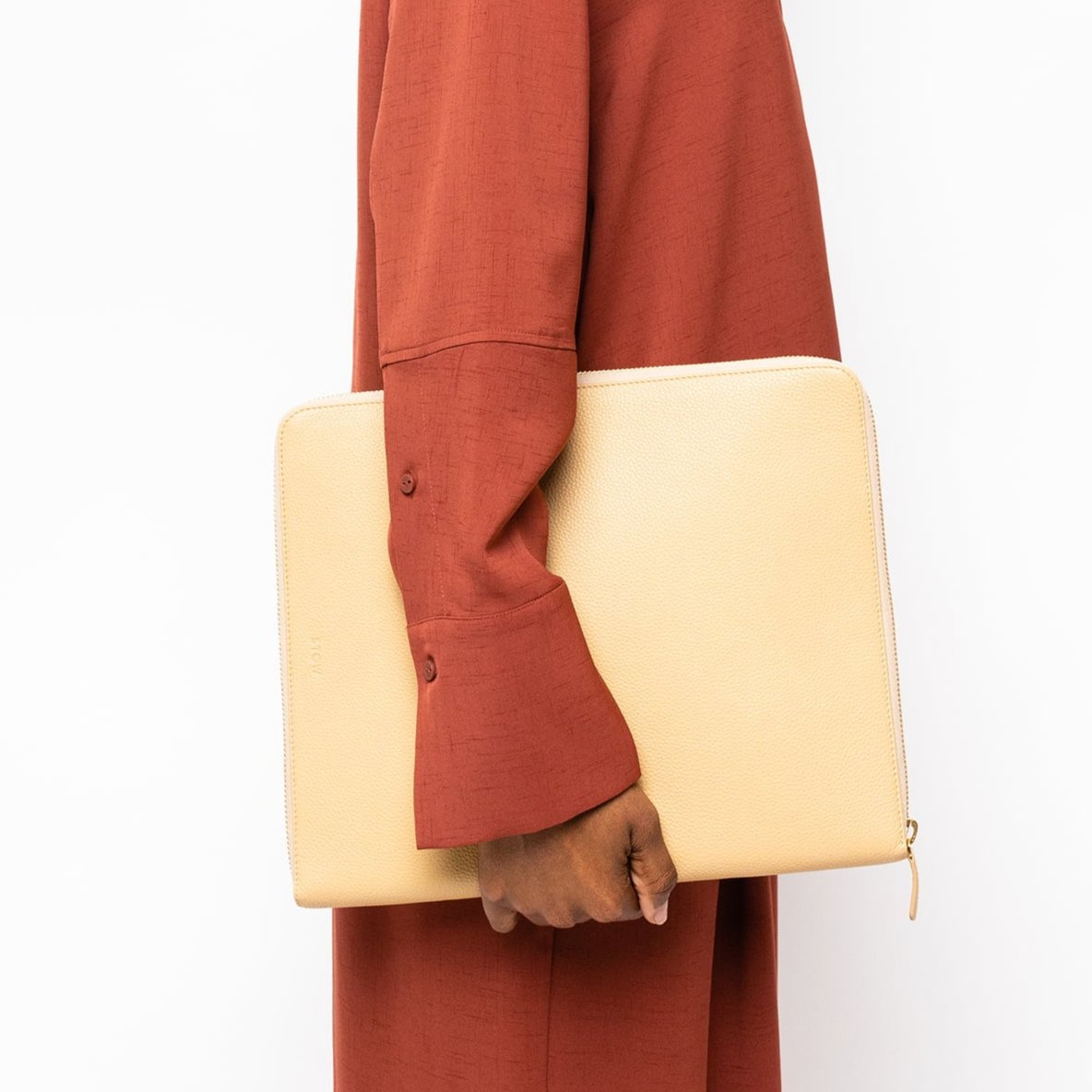 STOW London Executive Folio tech case in Almond leather carried by female model in studio image