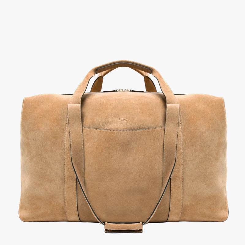 STOW London's Weekend bag in Soft Sand suede on a light grey background 