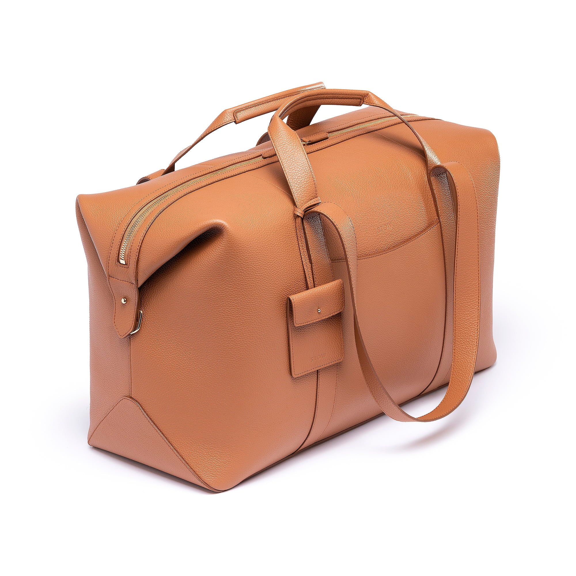 STOW Leather Multi Tag in Earth Tan pebbled leather shown hanging on Earth Tan Leather Weekend Bag by STOW.