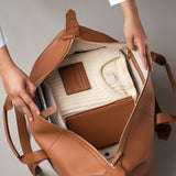 STOW Leather Cardholder in Earth Tan colour shown inside STOW Leather Weekend Bag in Earth Tan.