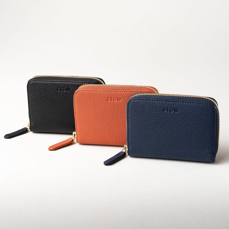 STOW Leather Zip Wallets in Black, Clay Orange and Navy pebbled leather.
