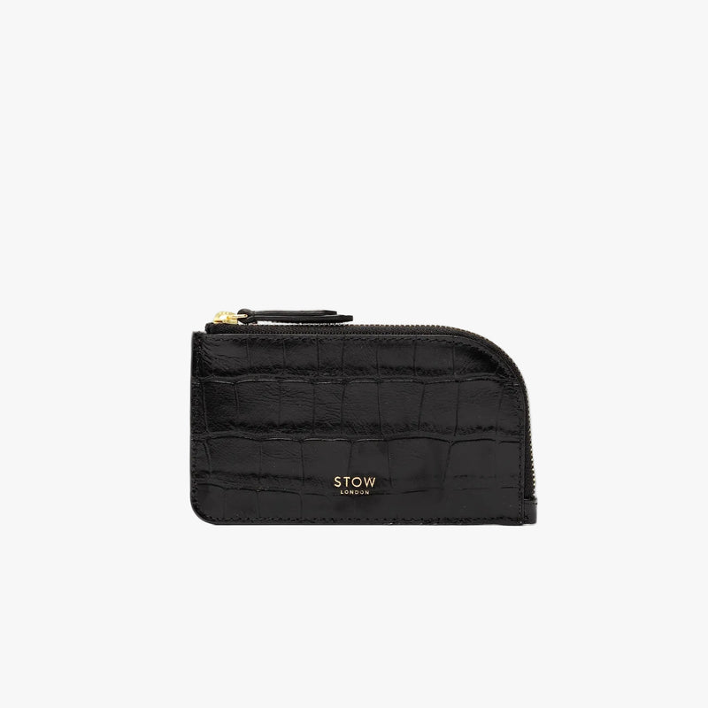 STOW London's Zip Wallet in Black Embossed Croc leather on a light grey background featuring a fine gold embossed logo and YKK Natulon zipper