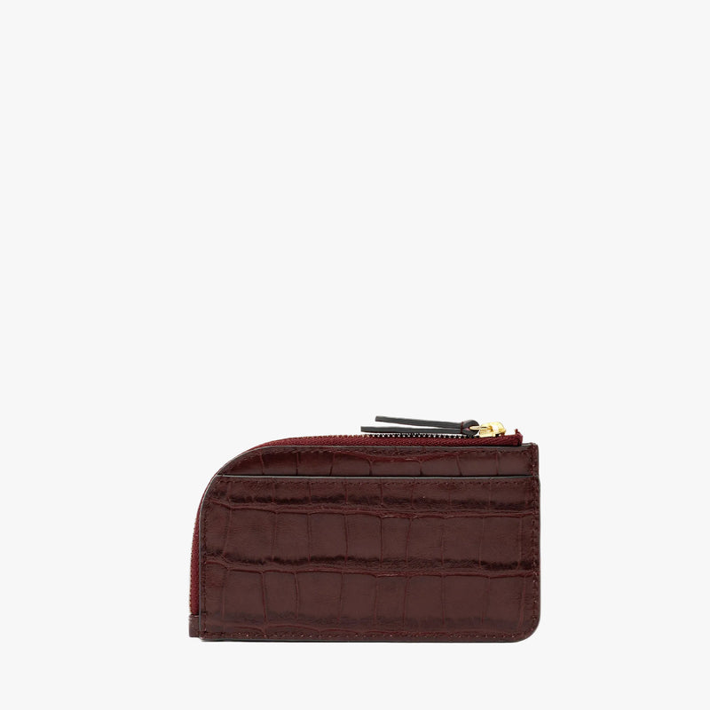 Back panel of STOW London's Zip Wallet in Burgundy Embossed Croc leather on a light grey background featuring a fine gold embossed logo and YKK Natulon zipper