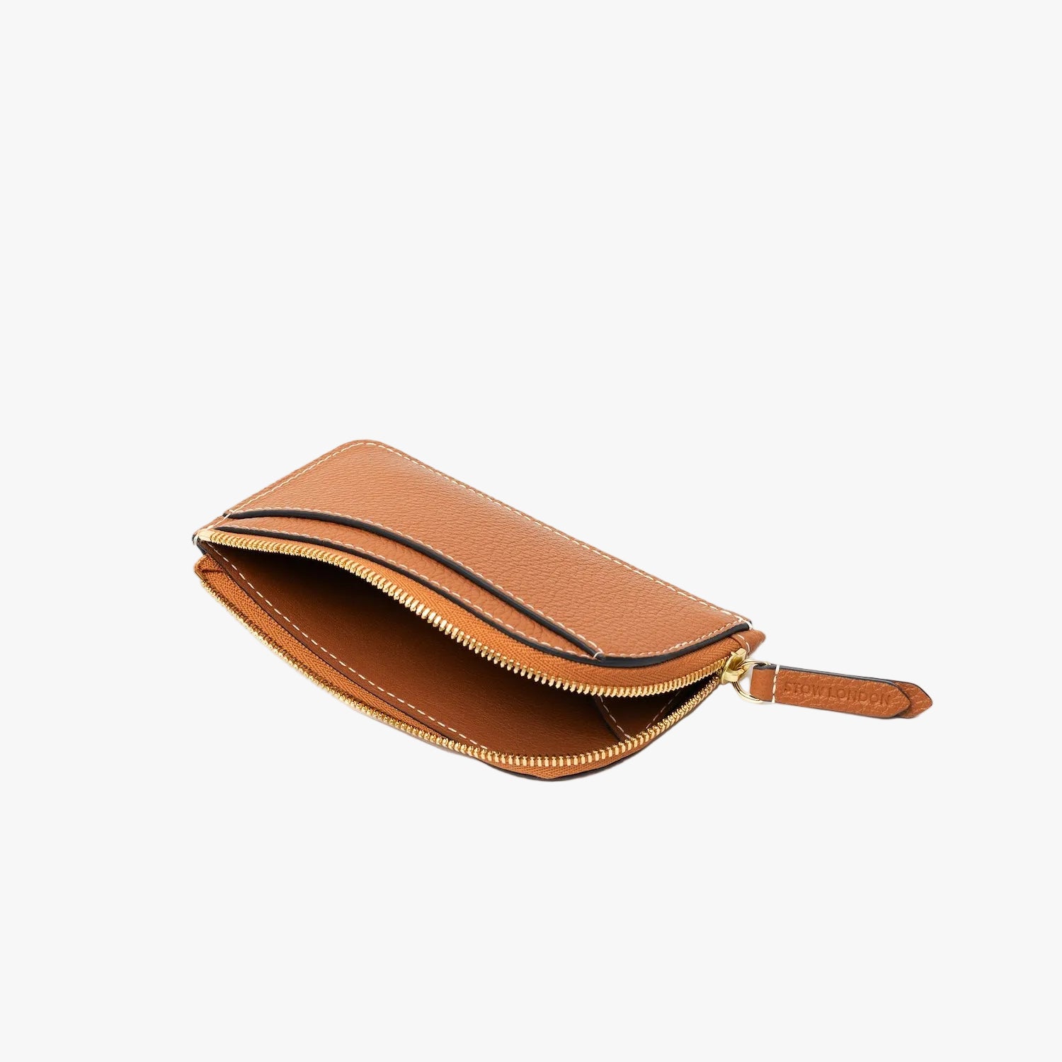 Top view of STOW London's Zip Wallet in Earth Tan pebbled leather on a light grey background with the zipper open showing the interior